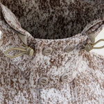 Front close-up view of WeatherWool's updated Double Hood, in Lynx Merino Jacquard Fabric. Now with 2 sets of slot buttons allowing for extra security and 3 buttoning options.