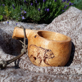 WeatherWool Advisor Eix, from Estonia, carved this Kuksa ... and the bear! The Kuksa is photographed on top of Eix's Al's Anorak in Lynx Pattern